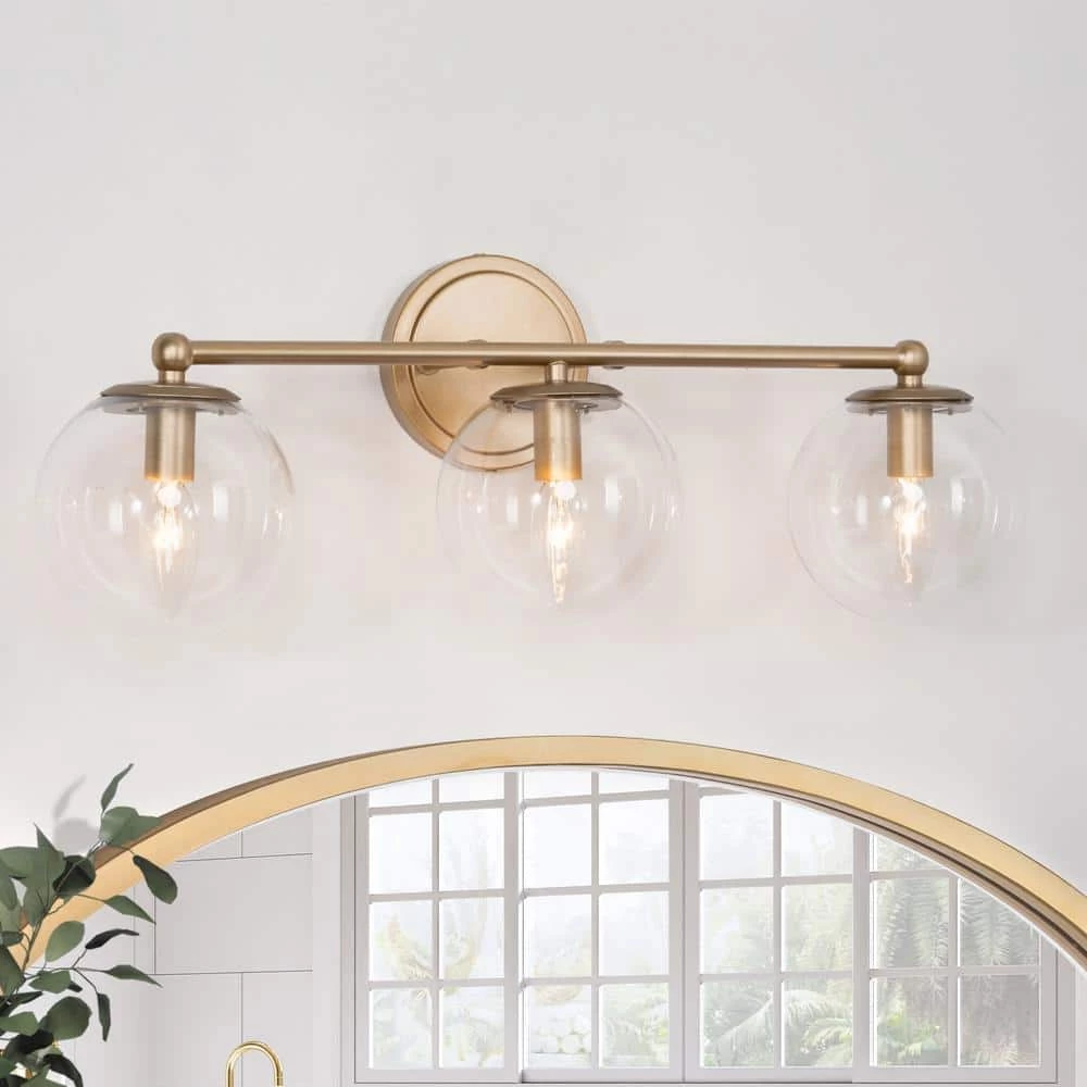 Modern Globe Bathroom Vanity Light Naomi 3-Light Brass Gold Round Powder Room Wall Sconce Light with Clear Glass Shades by Uolfin