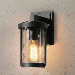 Modern Cylinder Outdoor Wall Light TORA 1-Light Industrial Matte Black Cage Wall Sconce Light with Water Glass Shade by Uolfin